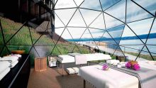 Luxury Anantara Spa treatment room at Ushuaia Patagonia Resort featuring glass dome design and breathtaking mountain and lake views.